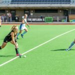 woman wearing black jersey playing on field